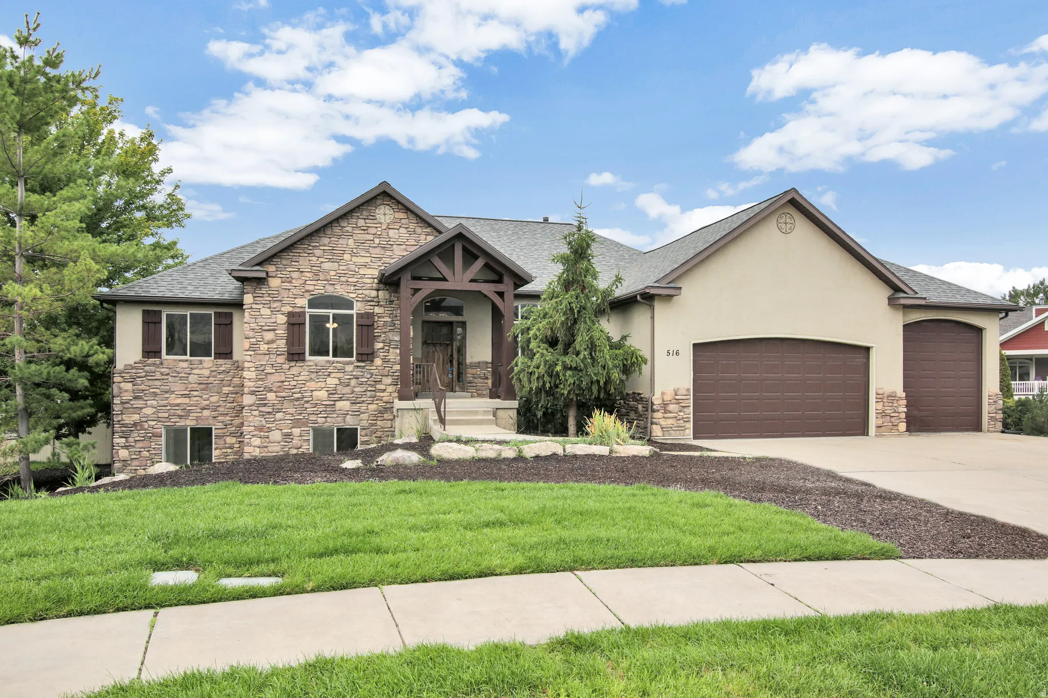 Stone and stucco exterior with multiple gables