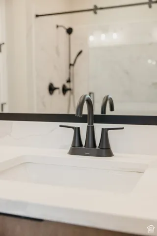 Undermount sink with a matte black faucet, set within a light-toned countertop