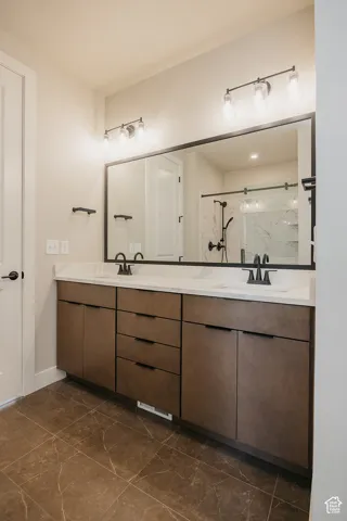 Dual sink vanity with quartz countertop, wood-finish cabinetry, and black hardware
