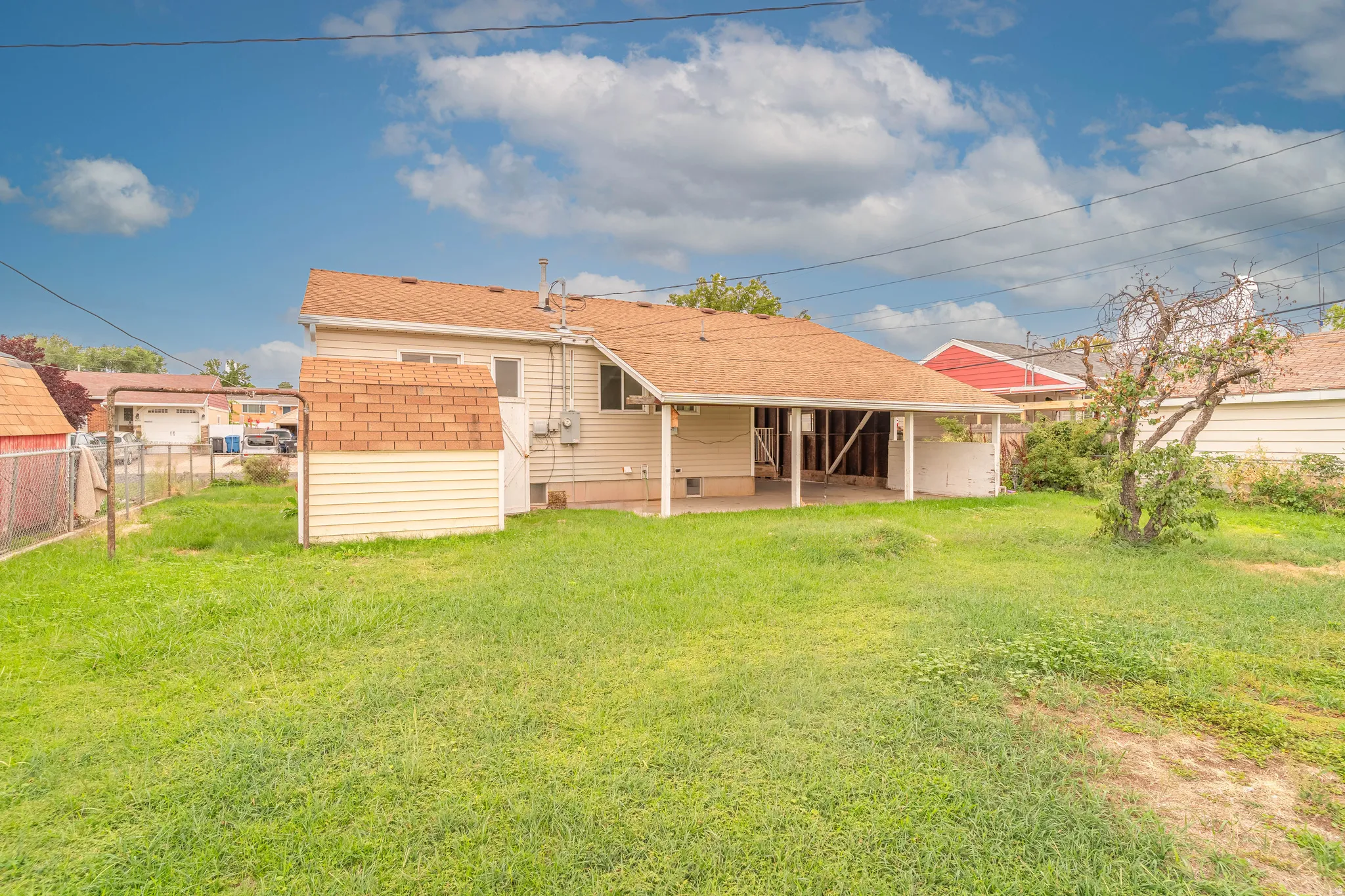 Back of House with Fenced Yard and Automatic Sprinklers AI generated