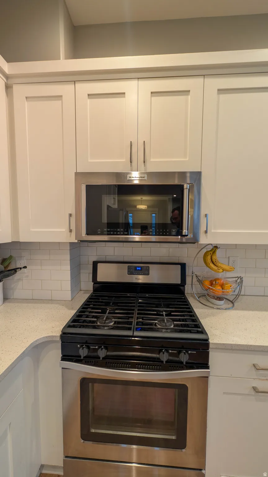 Stainless steel gas range with coordinating over-the-range microwave