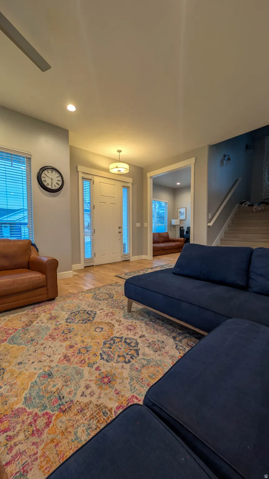 Entryway with wood-finish flooring, white trim, and a contemporary ceiling light fixture