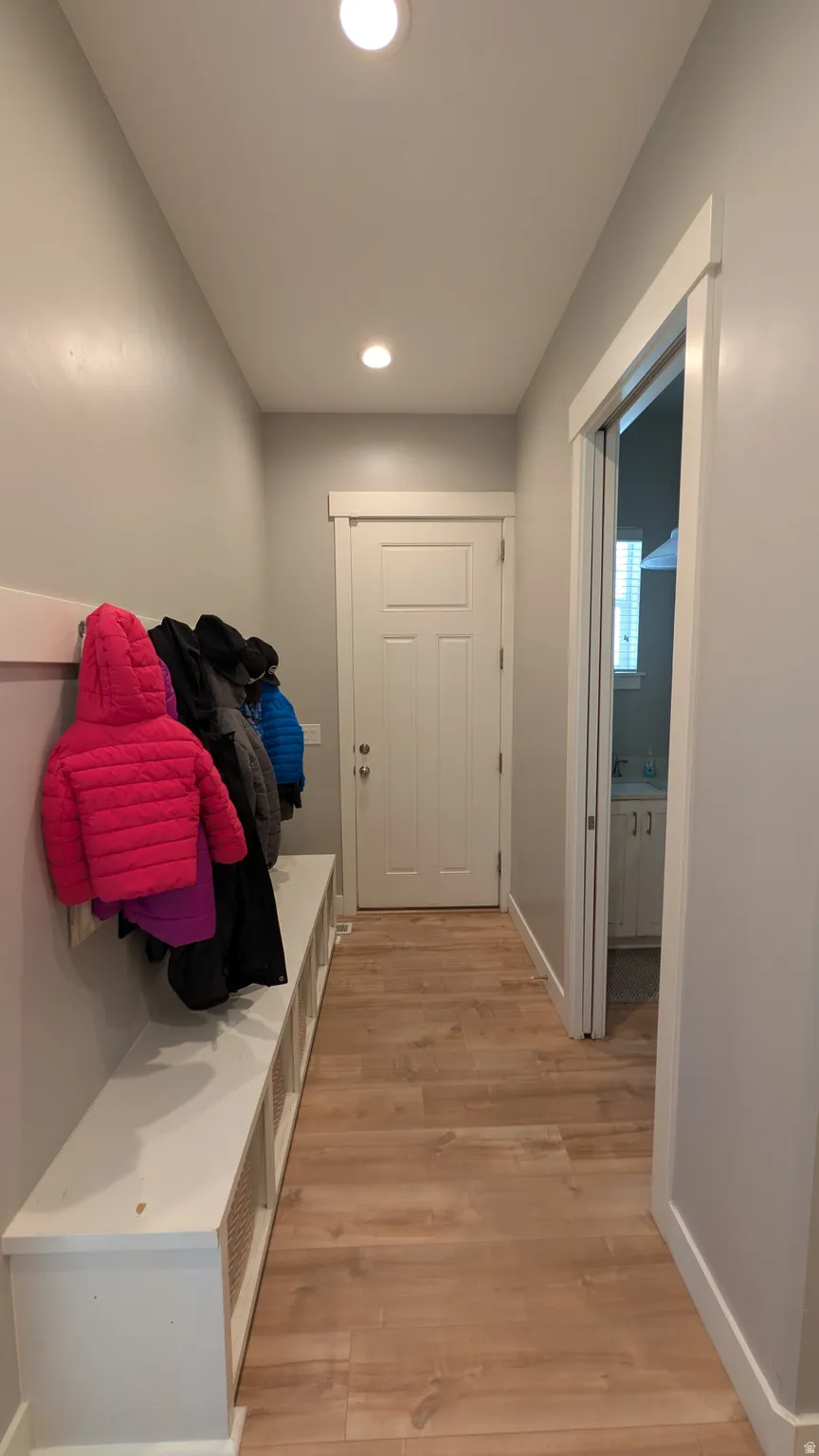 Entryway featuring wood-finish flooring and recessed lighting