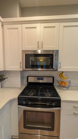 Stainless steel gas range with coordinating over-the-range microwave