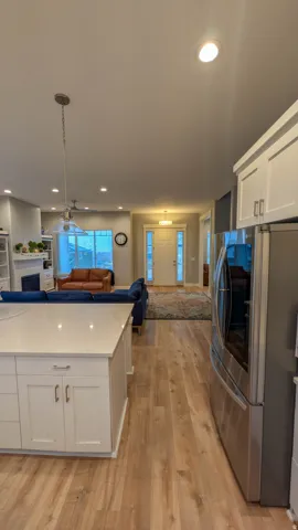 Gourmet kitchen island with white shaker cabinetry and a light-toned countertop