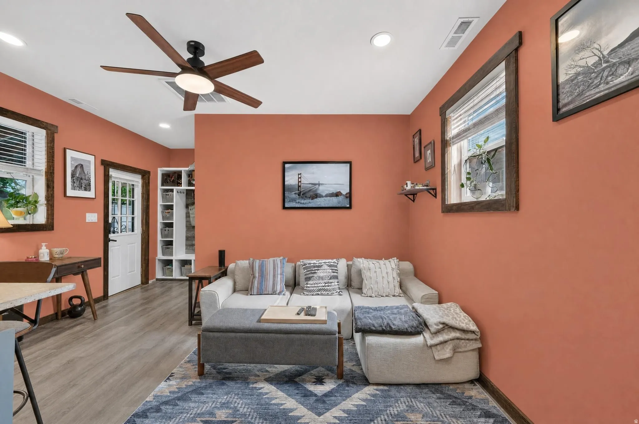 Recessed lighting, wood-finish flooring, ceiling fan with integrated light, built-in shelving, and white paneled door