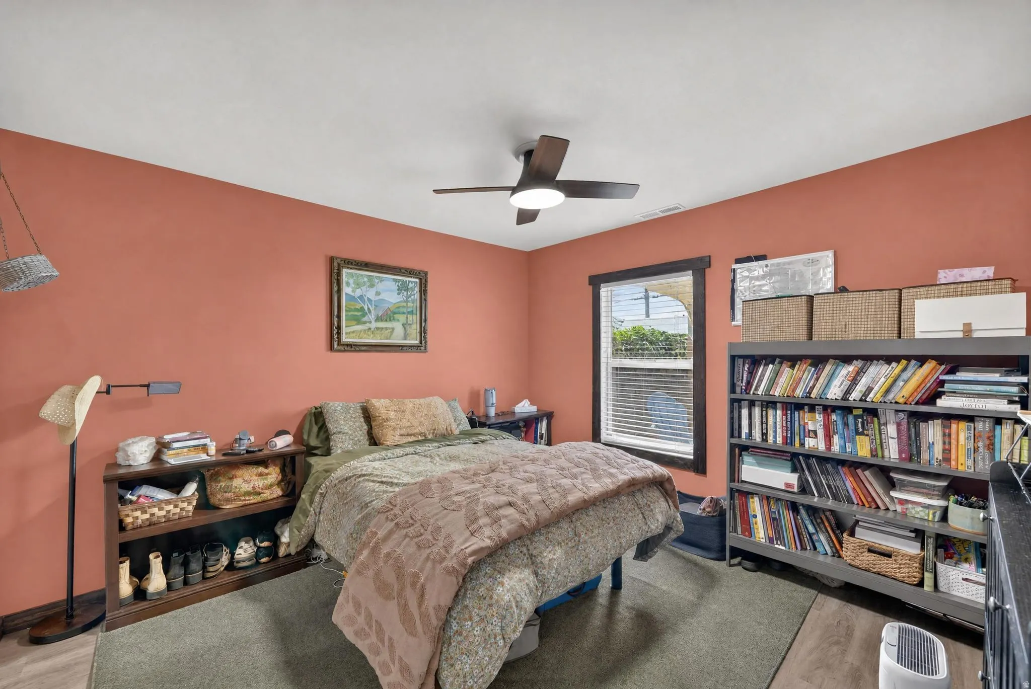 Ceiling fan with integrated lighting, wood-finish flooring, and a window with blinds