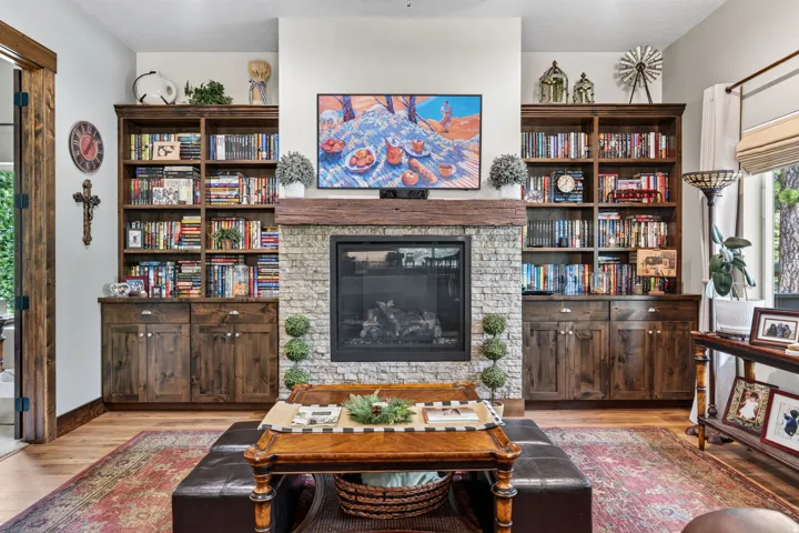 Stone-clad fireplace with a wood mantel