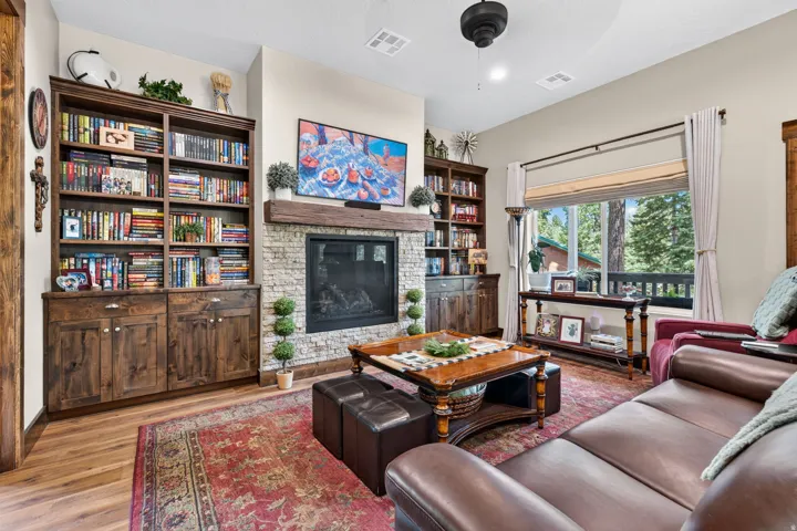 Stacked stone fireplace with a substantial wood mantel