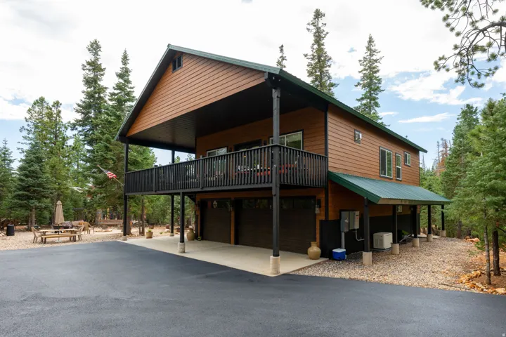 Cedar siding exterior with a metal roof and an elevated balcony