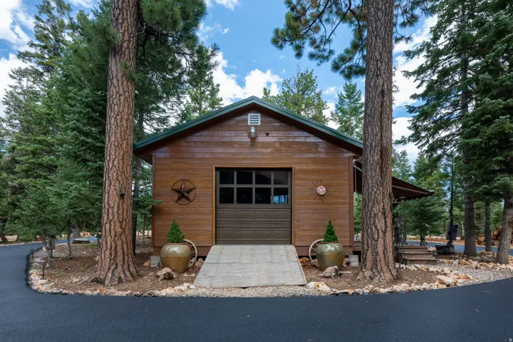 Wood-sided structure with a dark green pitched roof