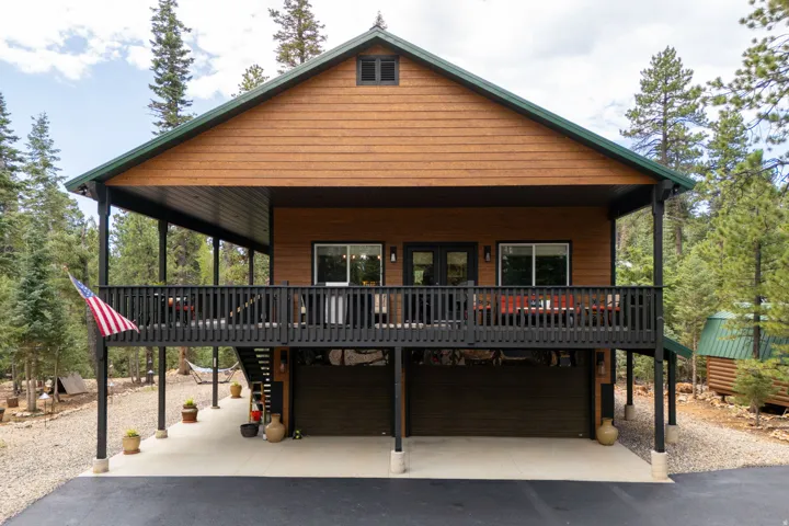 Wood-finish siding with a green shingle roof