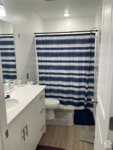 Bright, updated bathroom featuring a white vanity with ample storage, porcelain sink, and chrome fixtures