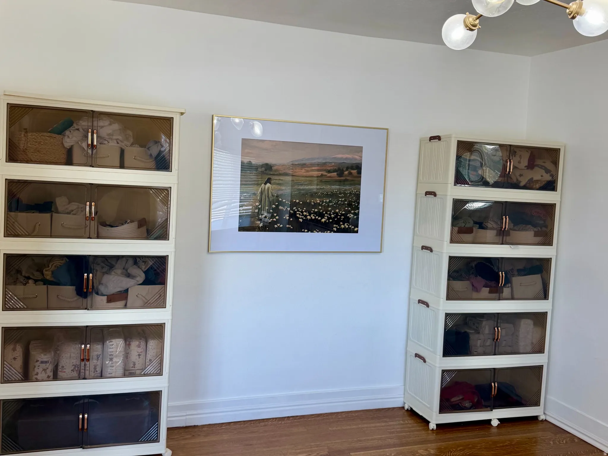 Hardwood flooring throughout featuring a modern ceiling light fixture