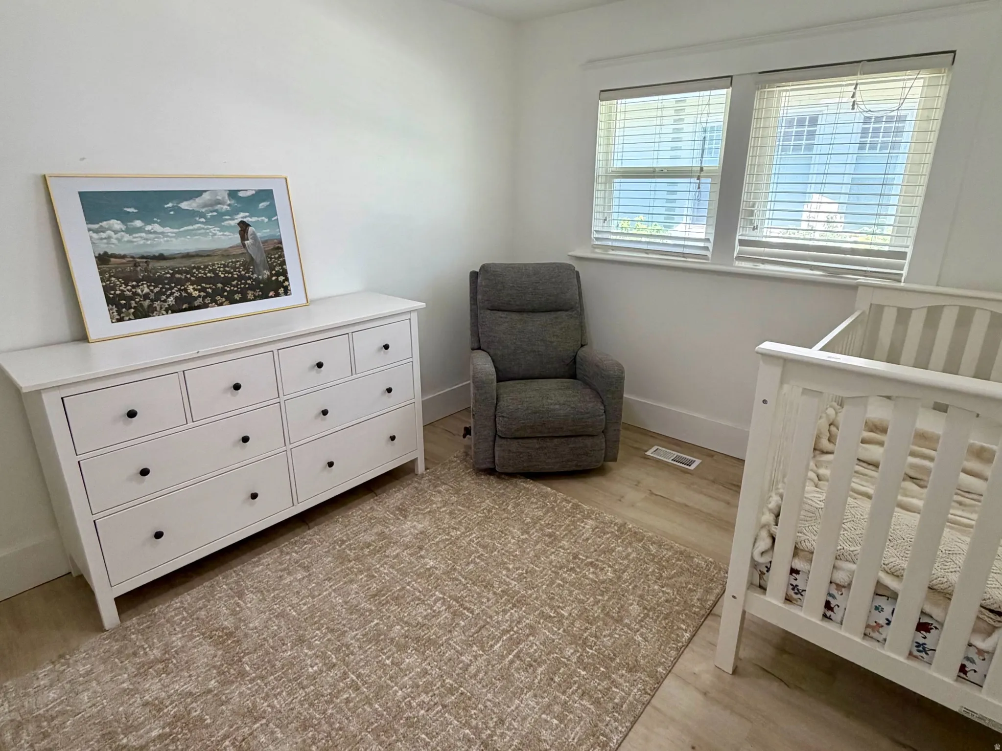 Recessed lighting, wood-finish flooring, and a ceiling fan with integrated light
