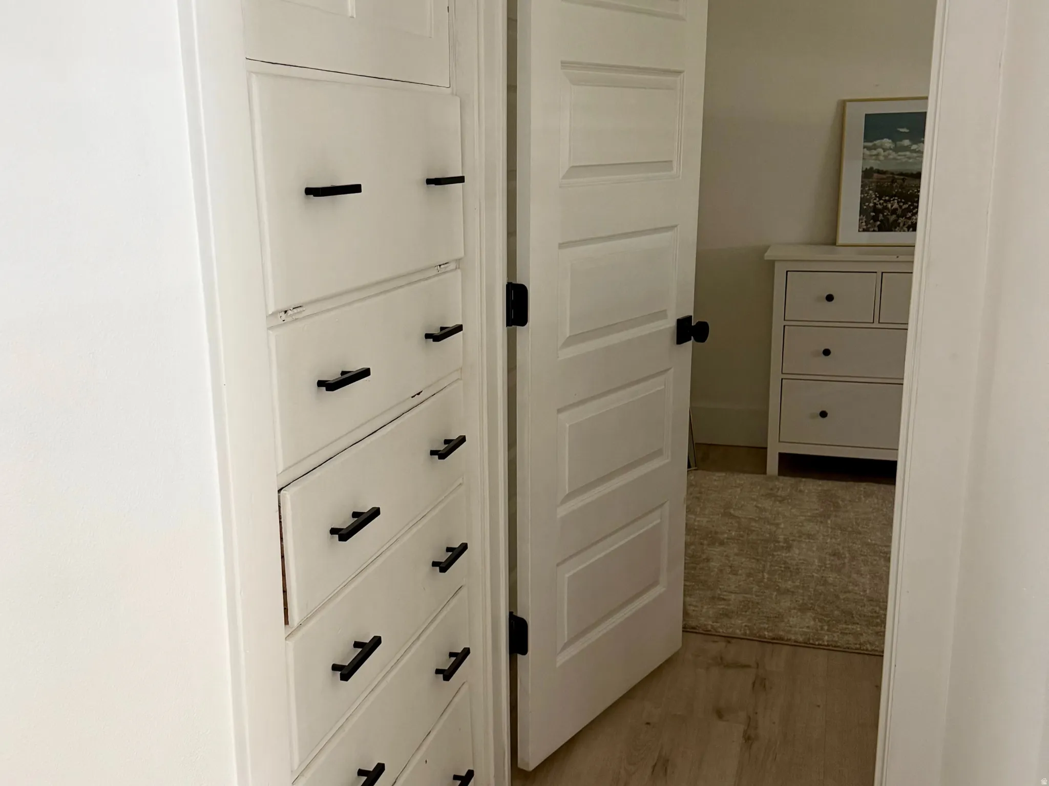 Built-in storage cabinetry featuring multiple drawers and upper cabinet