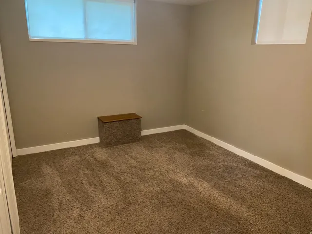 Neutral-toned walls complement plush carpeting