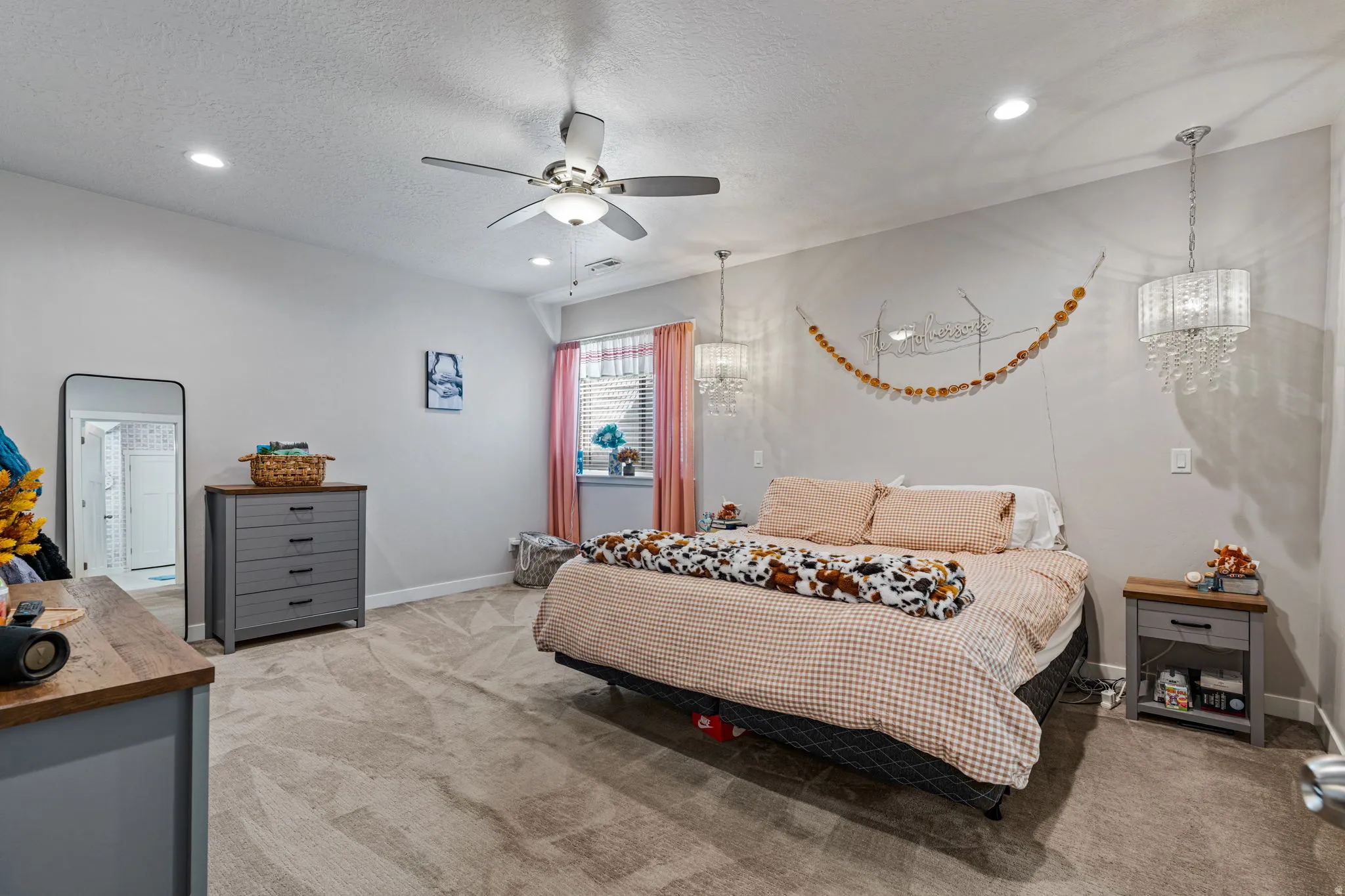 Recessed lighting, ceiling fan, window with blinds, carpeted flooring, and two decorative pendant lights