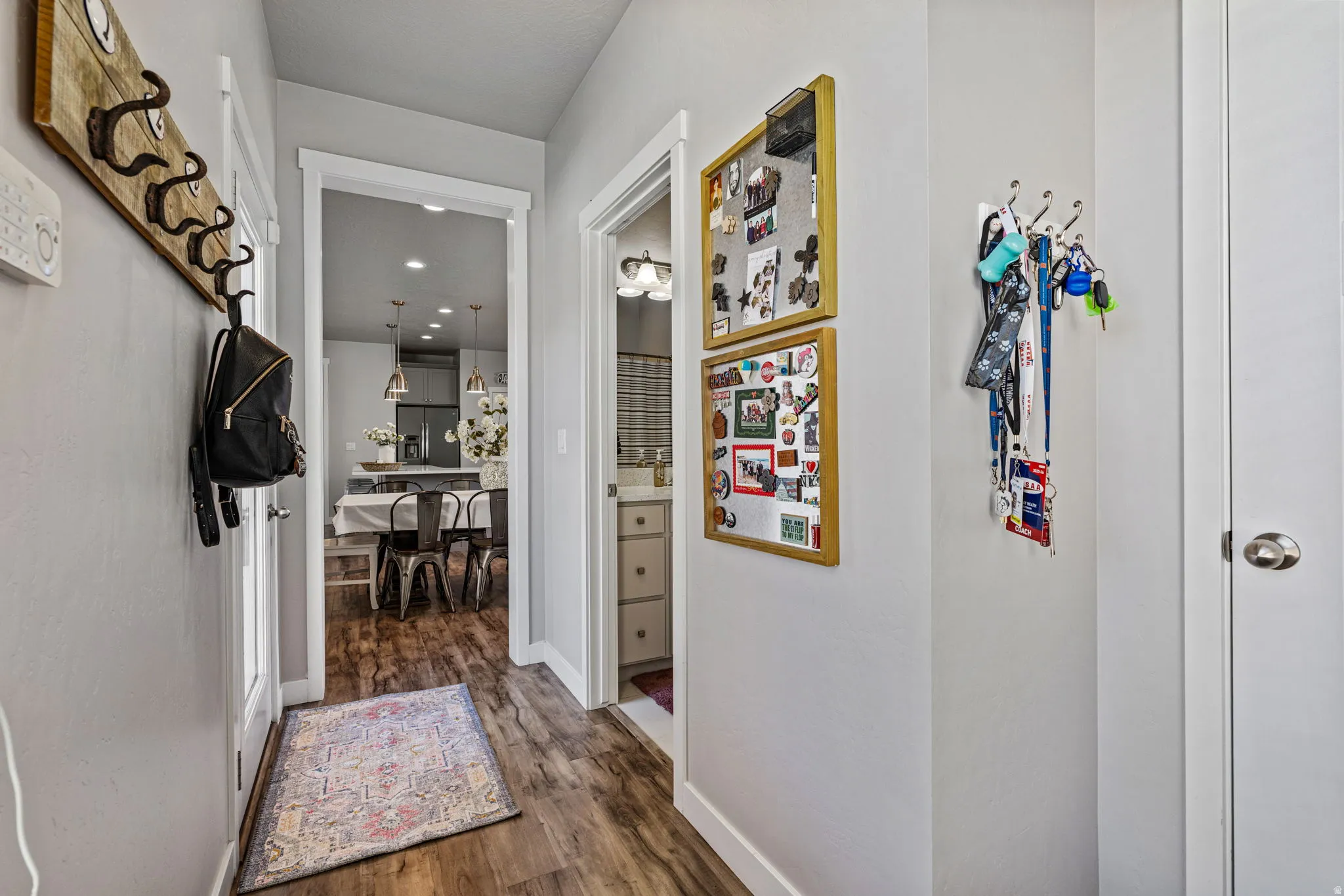Wood-finish flooring throughout, light gray wall paint, and white trim accents