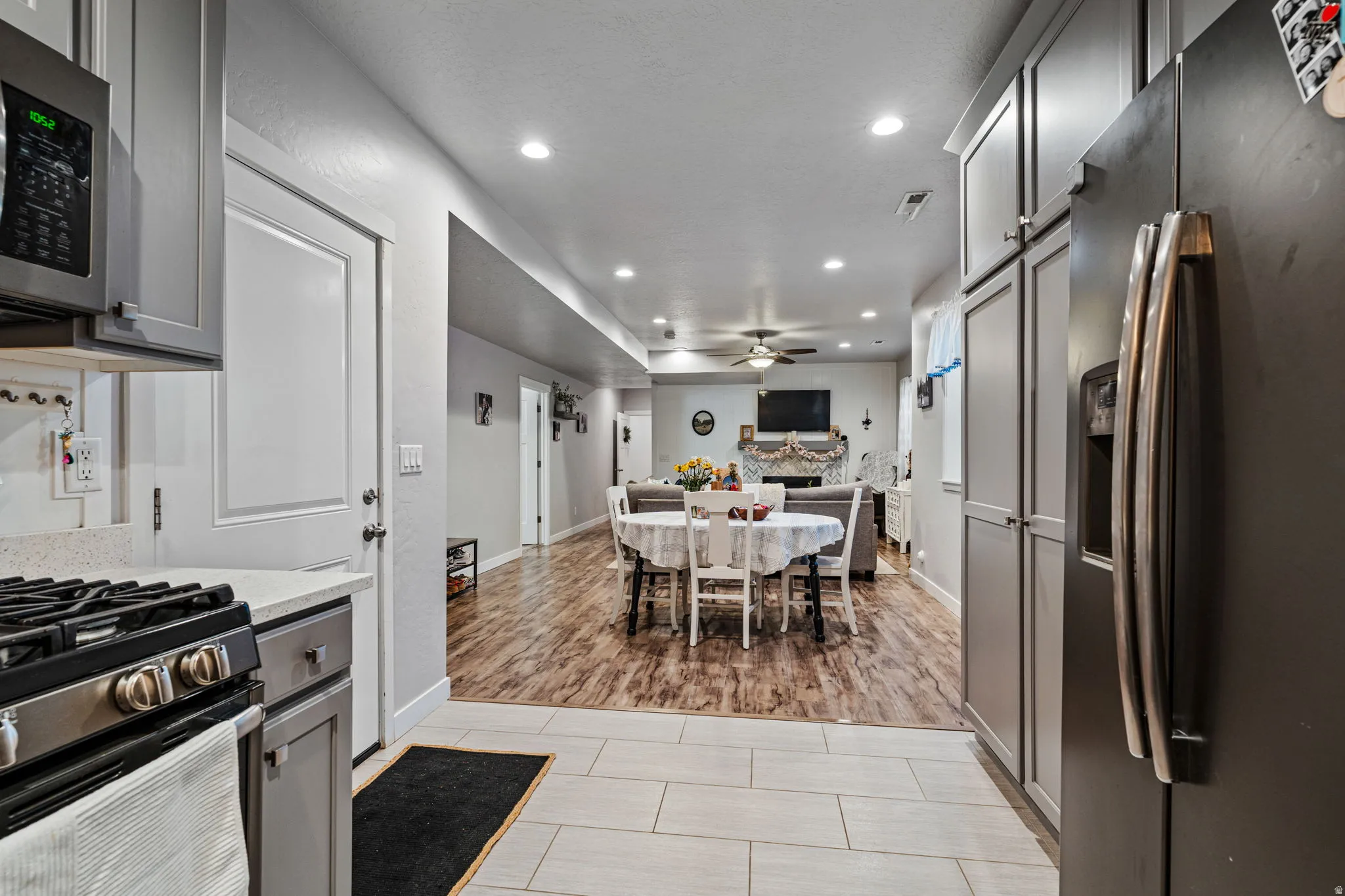 Kitchen featuring gray cabinetry, stainless steel appliances, and a light-toned countertop