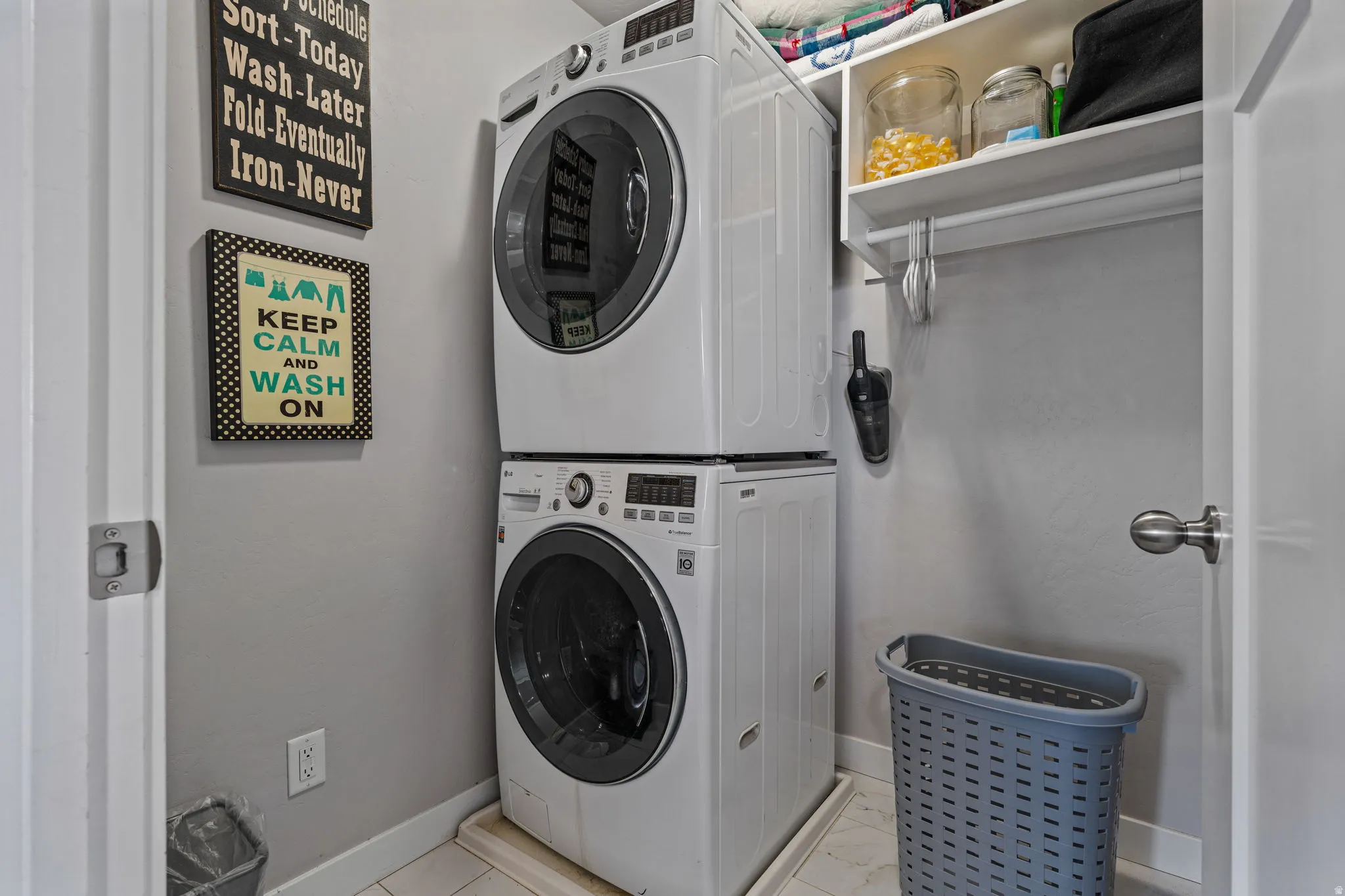 Stackable washer and dryer, built-in shelving, and a hanging rod