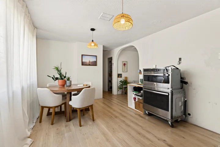 Hardwood-style flooring extends through the space