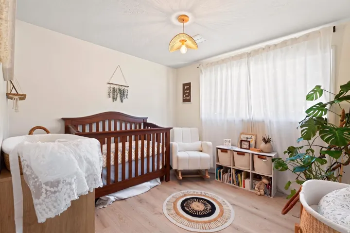 Wood-finish flooring, recessed lighting, and a window with sheer curtains