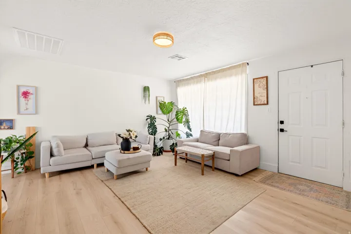 Light wood-finish flooring with white baseboards throughout