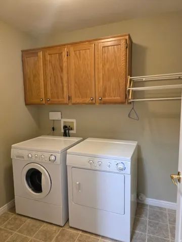 Upper wood cabinetry provides storage