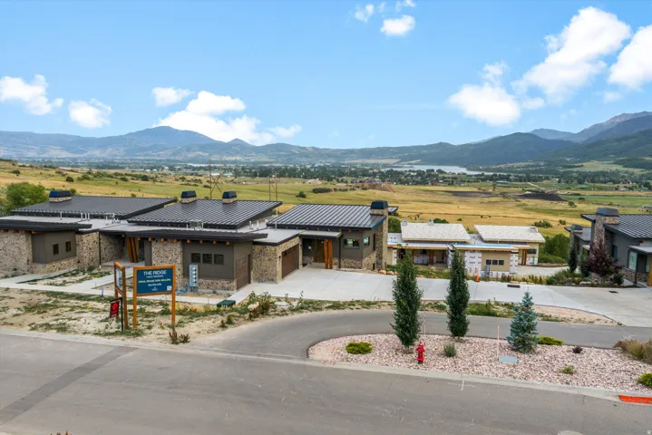 Modern residential property featuring a contemporary stone and stucco exterior with solar panel installation