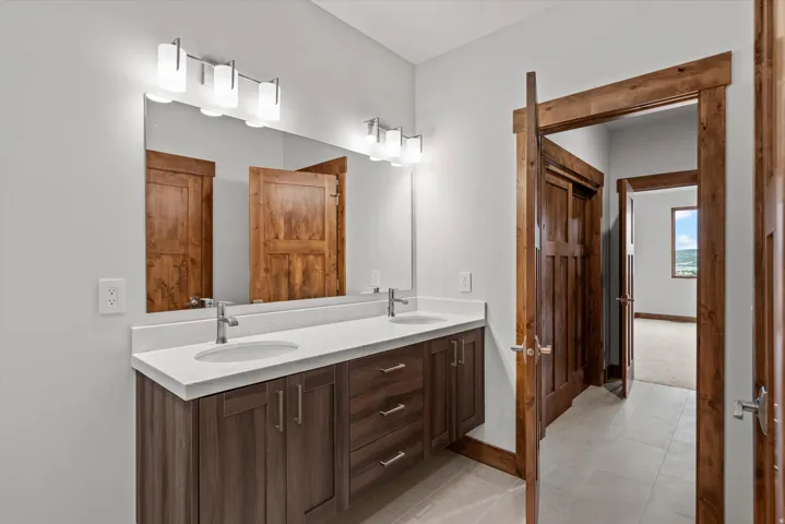 Double vanity with undermount sinks and a light-toned countertop