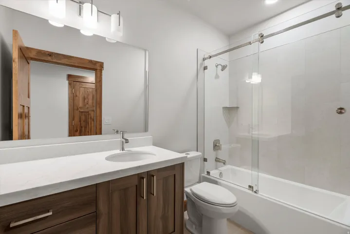 Bathroom vanity with a white countertop and wood-finish cabinetry