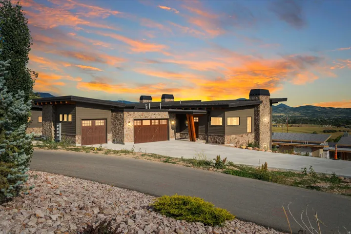 Modern exterior architecture featuring dark siding and stone accents