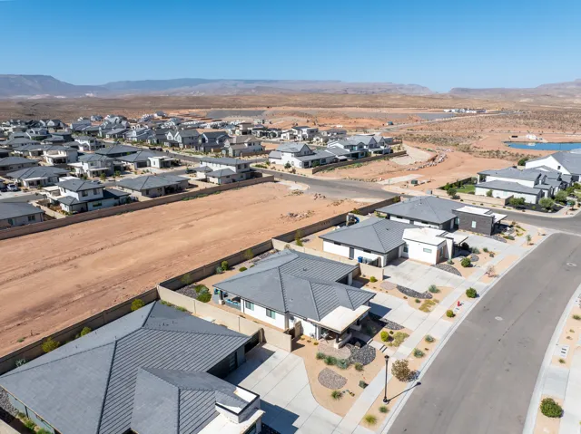 Desert landscape setting with a residential development, modern architectural design, and a flat roofline