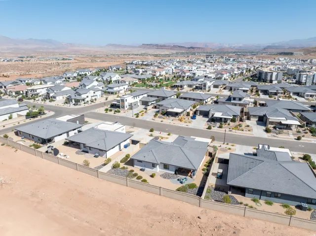 Residential community with distinct architectural styles, surrounded by desert landscaping and distant mountains