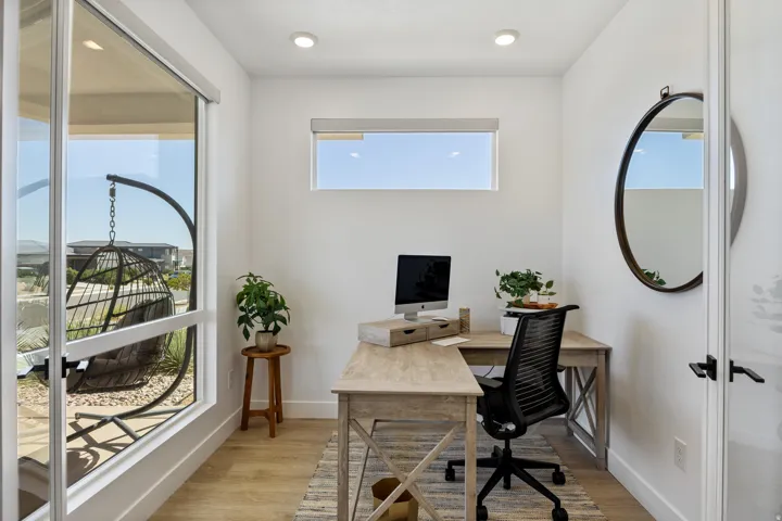 Recessed ceiling lighting, wood-finish flooring, white walls, large window, and horizontal transom window