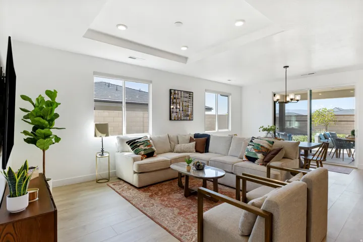 Recessed lighting, light wood-finish flooring, and multiple windows create a bright interior