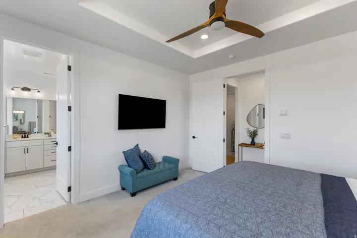 Tray ceiling with recessed lighting and a wood-blade ceiling fan