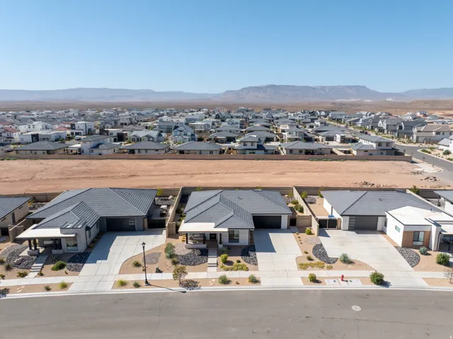 Modern residences featuring low-profile roofing, attached garages, and paved driveways