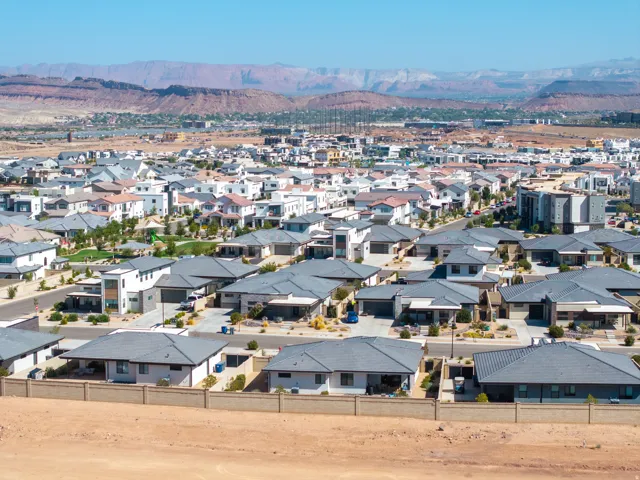 Expansive residential development with a mountain backdrop, featuring a mix of contemporary and traditional architectural styles