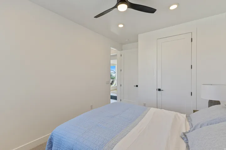 Recessed ceiling lighting, ceiling fan, carpeted flooring, and white interior doors with matte black hardware