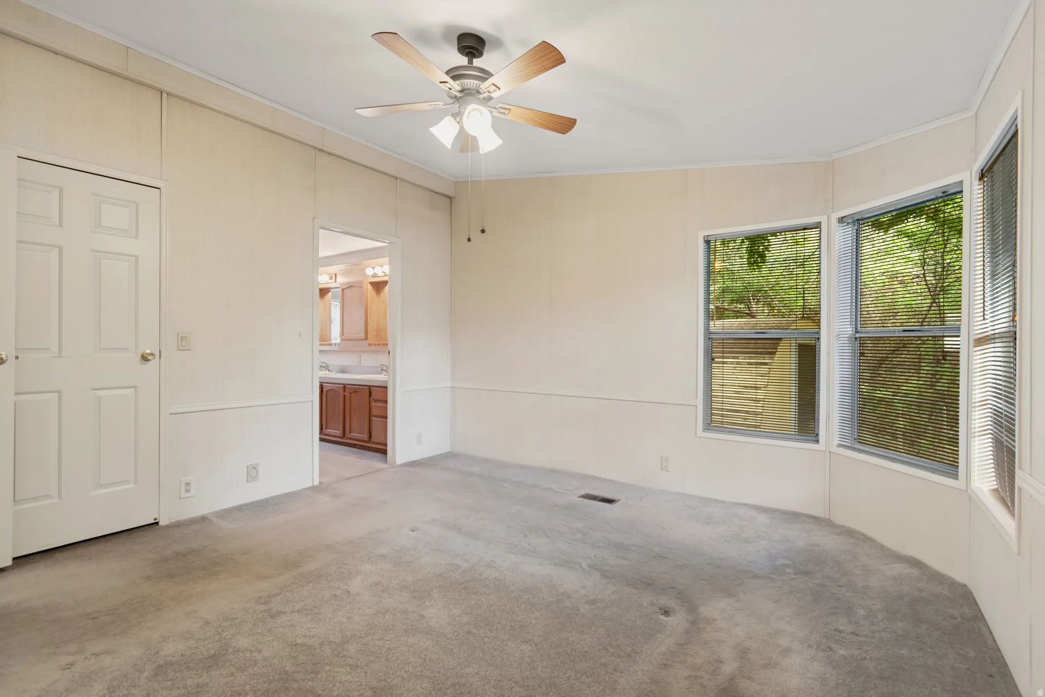 Primary Bedroom, doorway to primary bathroom and walk in closet.