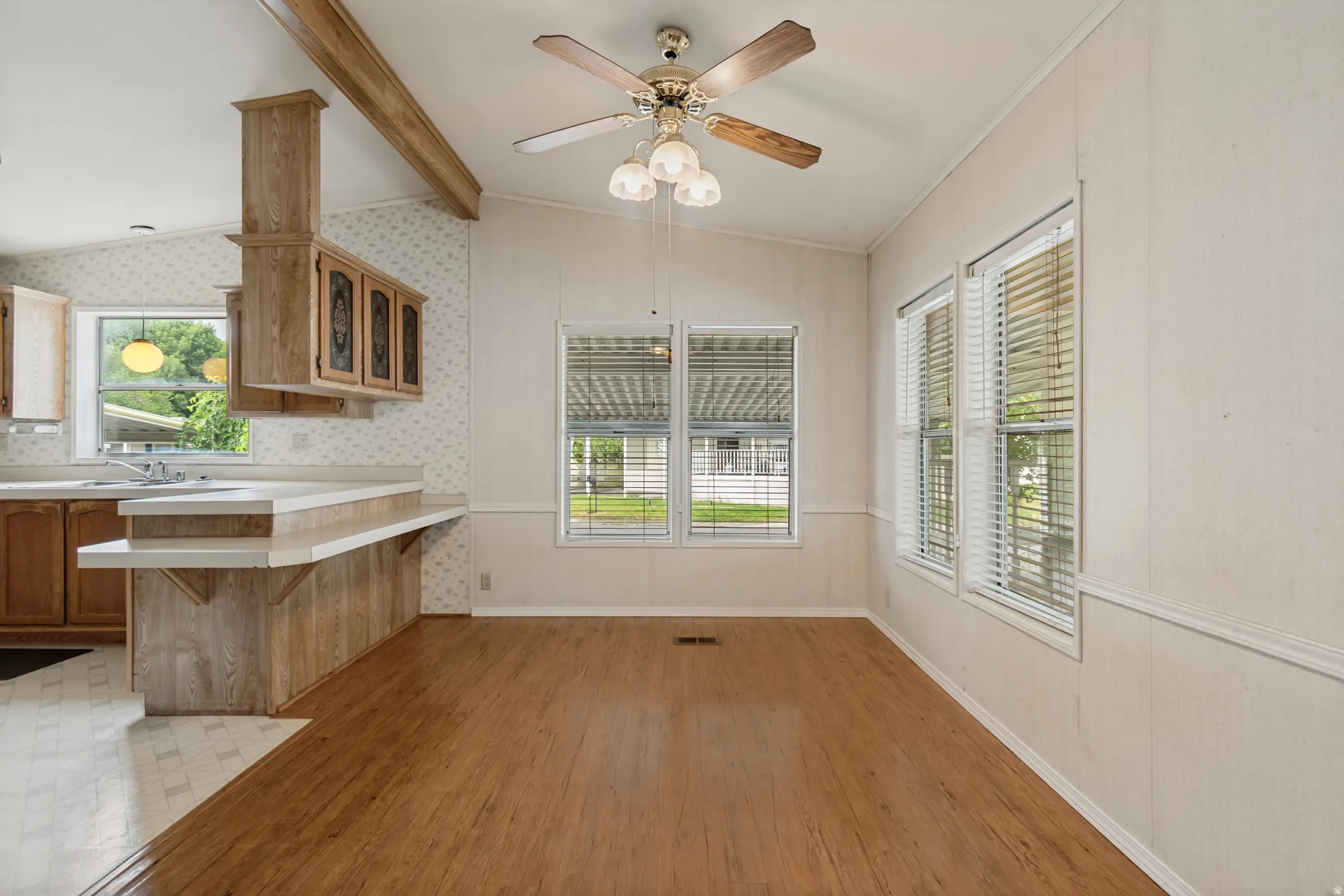 Wood-finish flooring with a ceiling fan overhead