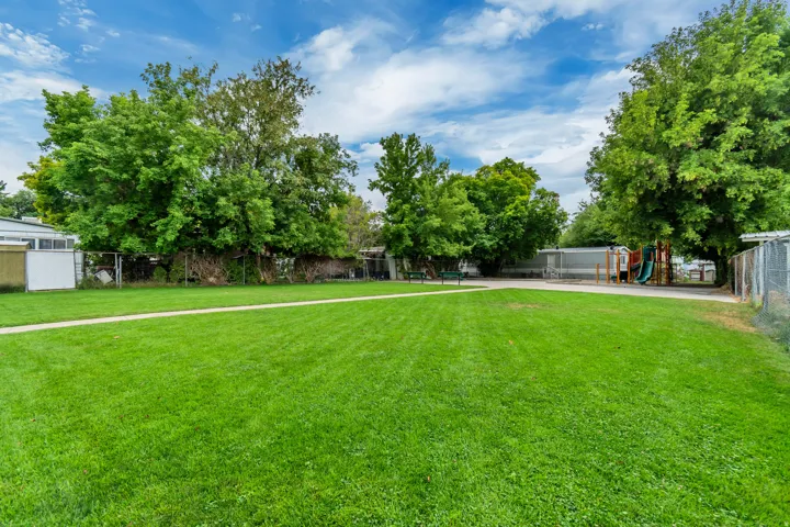 Park and playground with mature trees.