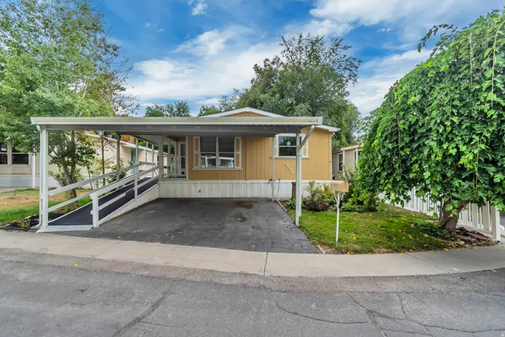 Front facade with double carport and ramp to front porch.