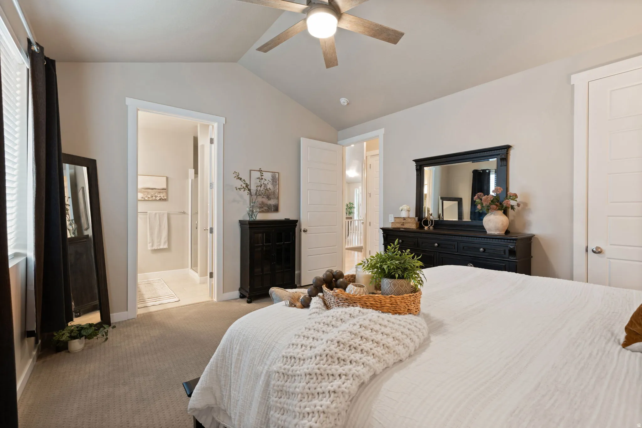 Vaulted ceiling with ceiling fan, carpeted flooring, and a window with blinds