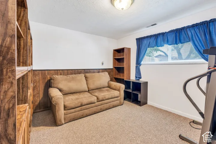 Warm interior room with wood-panel wainscoting and white walls