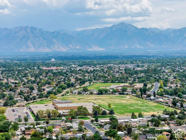 Expansive residential area featuring a prominent mountain backdrop and widespread mature trees