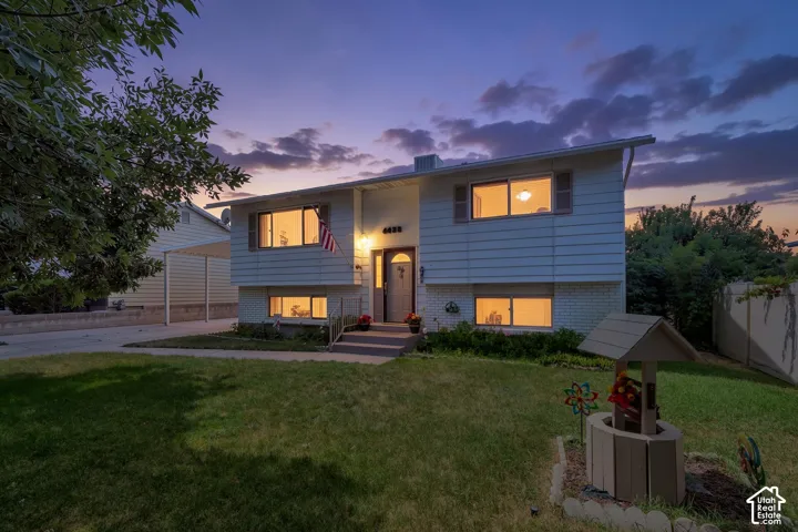 Split-level home with white siding and brick accents