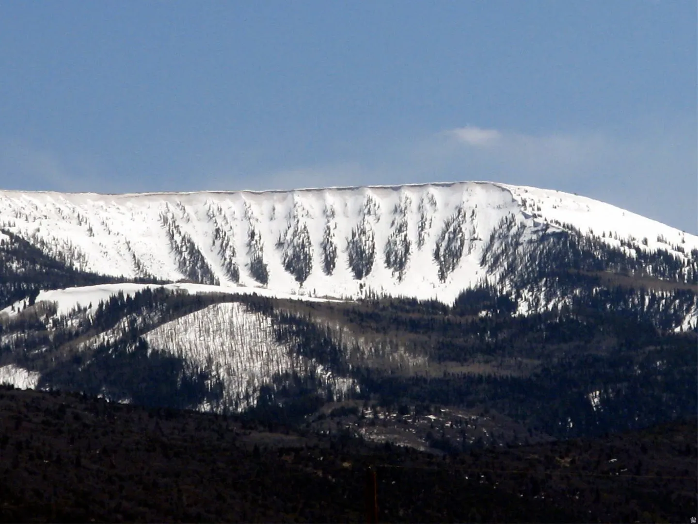 Snow-capped mountain range under a clear sky